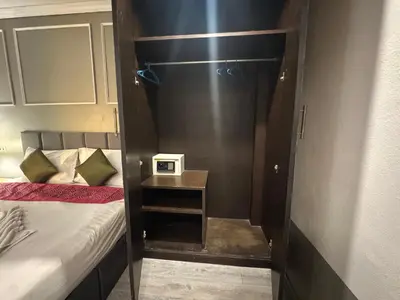 a small room with a bed and a small table at At bedroom in Patong Beach