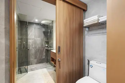a bathroom with a toilet and a shower at Laguna beachside residences by My home Phuket in Bang Tao Beach