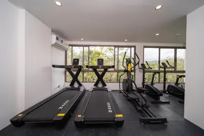 a gym with treadmills and elliptical machines at Japanese-Style Condo close Kamala Beach in Kamala Beach