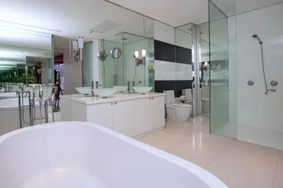 a bathroom with two sinks and a shower at Private 3-Storey Pool Villa Atika 10, for 7, views of Patong Bay in Patong Beach