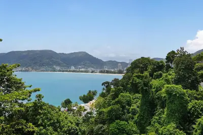 a view of a beach from a hill with trees at Private 3-Storey Pool Villa Atika 10, for 7, views of Patong Bay in Patong Beach