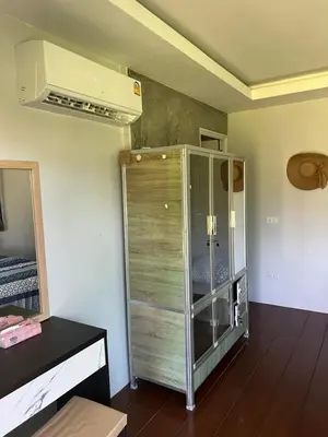 a room with a glass cabinet in a room at Nature Home in Phang-nga