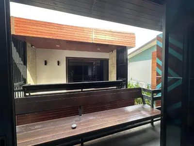 a wooden bench sitting on a balcony at โรงแรมชาวเกาะพีพี Chaokoh Phi Phi Island in Phi Phi Don