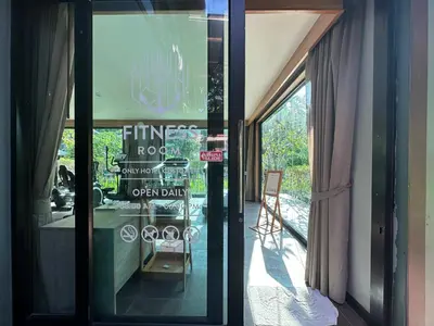 a glass door to a restaurant with a sign on it at โรงแรมชาวเกาะพีพี Chaokoh Phi Phi Island in Phi Phi Don