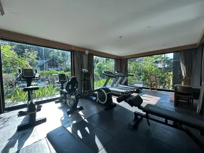 a gym with a large window and some tread machines at โรงแรมชาวเกาะพีพี Chaokoh Phi Phi Island in Phi Phi Don