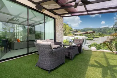 an outdoor patio with wicker chairs and a table at Nature and Sea View Terrace, Designer 2BR Villa Natural Touch A1, Kamala in Kamala Beach