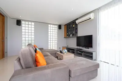 a living room with a couch and a flat screen tv at Nature and Sea View Terrace, Designer 2BR Villa Natural Touch A1, Kamala in Kamala Beach