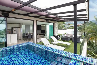 a swimming pool on the patio of a house at Nature and Sea View Terrace, Designer 2BR Villa Natural Touch A1, Kamala in Kamala Beach