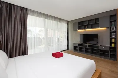 a bedroom with a white bed with a red box on it at Nature and Sea View Terrace, Designer 2BR Villa Natural Touch A1, Kamala in Kamala Beach