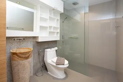 a bathroom with a toilet and a glass shower at Nature and Sea View Terrace, Designer 2BR Villa Natural Touch A1, Kamala in Kamala Beach