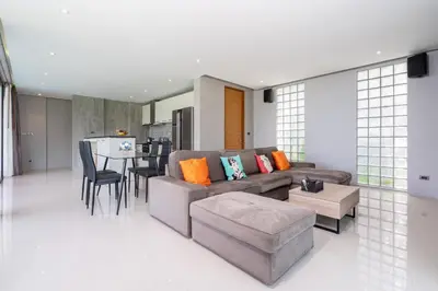 a living room with a couch and a table at Nature and Sea View Terrace, Designer 2BR Villa Natural Touch A1, Kamala in Kamala Beach