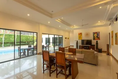 a living room with a table and a couch at V170 4BR Timbuktu villa, Jacuzzi Walk Villa Market in Chalong