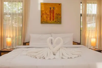 two white swans sitting on top of a bed at V170 4BR Timbuktu villa, Jacuzzi Walk Villa Market in Chalong