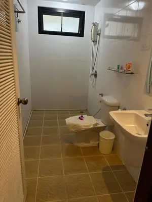 a bathroom with a toilet and a sink at Theclickguesthouse in Ban Bang Chak