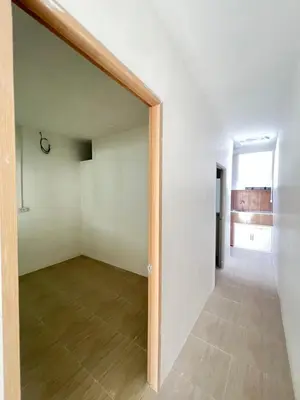 an empty room with a door leading to a hallway at Tim House Thalang Phuket 1 in Thalang