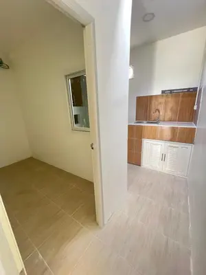 an empty room with a kitchen in a house at Tim House Thalang Phuket 1 in Thalang