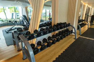 a gym with a bunch of dumbbells on a wall at Amazing View Duplex La Vita in Phuket Town