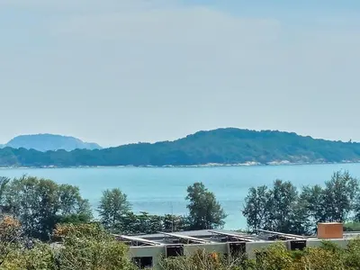 a view of a large body of water with trees at Amazing View Duplex La Vita in Phuket Town