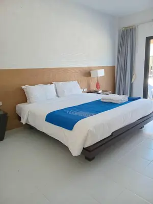 a bedroom with a large bed with a blue blanket at PaKrongCheep Homestay in Ban Muang Mai