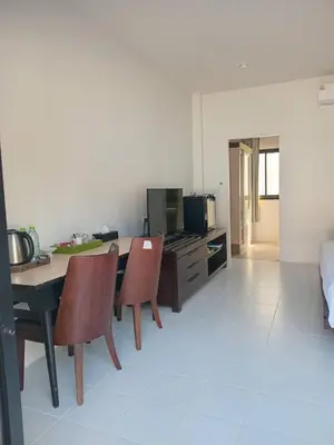 a kitchen with a table and chairs in a room at PaKrongCheep Homestay in Ban Muang Mai