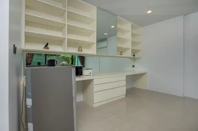 a kitchen with white cabinets and a refrigerator at 4BR Villa B5 with Pool, Vibrant Life at Kata Beach - UTK5 in Kata Beach