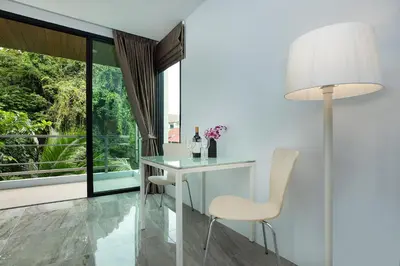 a white table and chair in a room with a window at 4BR Villa B5 with Pool, Vibrant Life at Kata Beach - UTK5 in Kata Beach