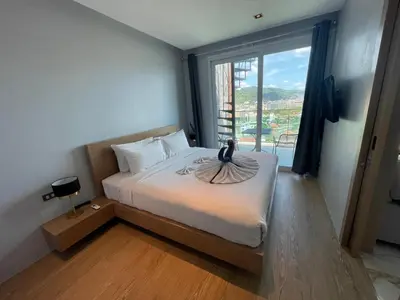 a bedroom with a bed with a bird on it at Emerald Terrace Resort 2 bedrooms Panoramic Ocean View Top Floor in Patong Beach