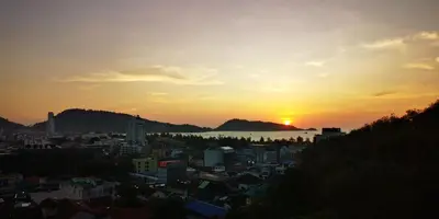 a view of a city at sunset at Emerald Terrace Resort 2 bedrooms Panoramic Ocean View Top Floor in Patong Beach