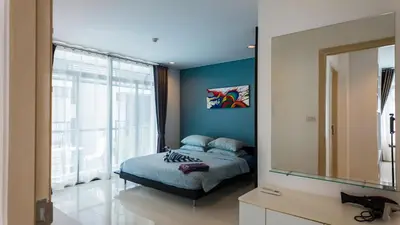 a bedroom with a bed and a large window at Apartment 2 bedrooms on Kamala in Phuket Town