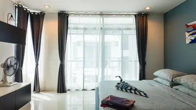 a bedroom with a bed and a large window at Apartment 2 bedrooms on Kamala in Phuket Town