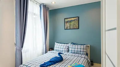 a bedroom with a bed with a toy dinosaur on it at Apartment 2 bedrooms on Kamala in Phuket Town