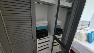 a room with a closet with towels and a mirror at Allamanda Laguna in Laguna Phuket