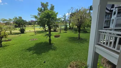 a view from a balcony of a yard with trees at Allamanda Laguna in Laguna Phuket