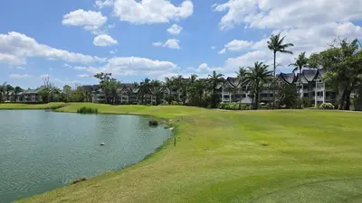 a view of a golf course with a pond at Allamanda Laguna in Laguna Phuket