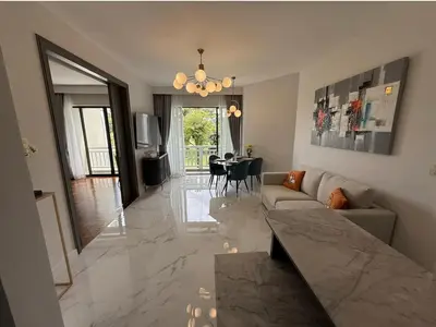 a living room with a couch and a dining room at Allamanda Laguna in Laguna Phuket