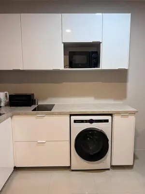 a kitchen with a washing machine and a microwave at Chic Condo Karon A512 in Karon Beach