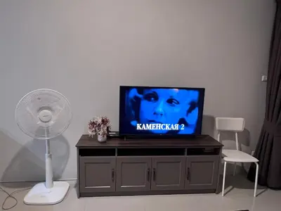 a flat screen tv sitting on top of a entertainment center at Chic Condo Karon A512 in Karon Beach
