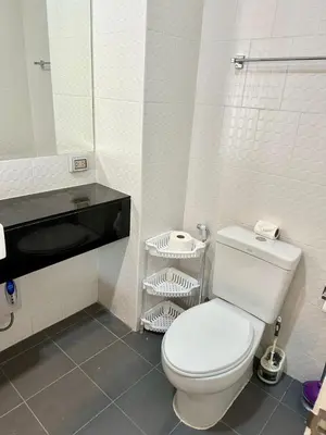 a bathroom with a white toilet and a mirror at Chic Condo Karon A512 in Karon Beach