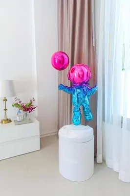 a plastic figurine sitting on a stool with two frisbees at Beachfront Luxury villa near Banyan Tree in Layan Beach