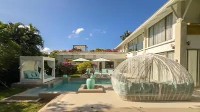 a swimming pool with a bird cage next to a building at Beachfront Luxury villa near Banyan Tree in Layan Beach