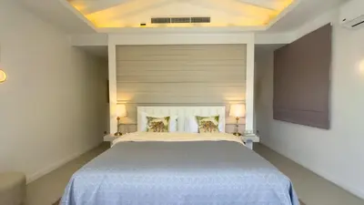 a bedroom with a large bed with two pillows at Beachfront Luxury villa near Banyan Tree in Layan Beach
