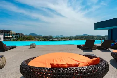 a circular bed sitting on a patio next to a pool at Wonderful View Duplex in La Vita in Rawai Beach