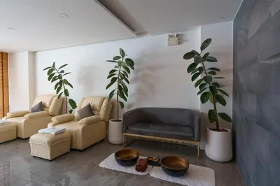 a living room with two couches and two plants at Wonderful View Duplex in La Vita in Rawai Beach