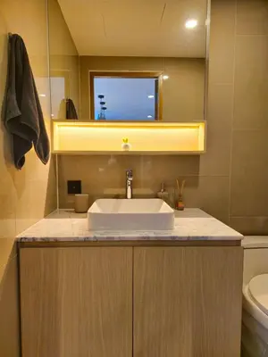 a bathroom with a sink and a tv on the wall at Wonderful View Duplex in La Vita in Rawai Beach