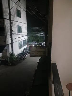 a view of a street with a sign in front of a building at CİMELi Guest House in Patong Beach