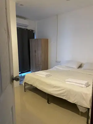 a bedroom with a bed with two towels on it at CİMELi Guest House in Patong Beach