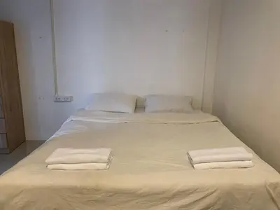 a large bed with two white towels on it at CİMELi Guest House in Patong Beach