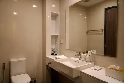 a bathroom with a sink and a toilet and a mirror at Private pool villa bangtao - laguna park in Ban Phru Champa