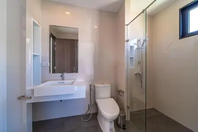 a bathroom with a toilet and a sink and a shower at Private pool villa bangtao - laguna park in Ban Phru Champa