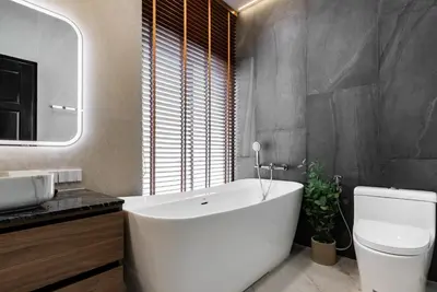 a bathroom with a tub and a toilet and a sink at Med Village by Villacarte in Nai Harn Beach